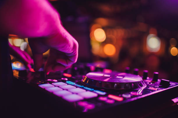 DJ remote, turntables, and hands . Night life at the club, party. stock photo