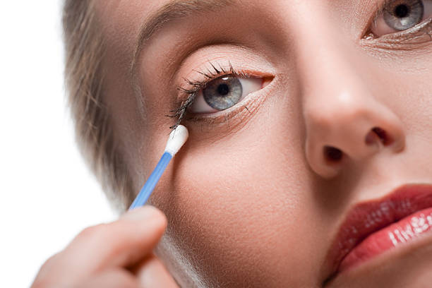 Removing make-up with cotton bud stock photo