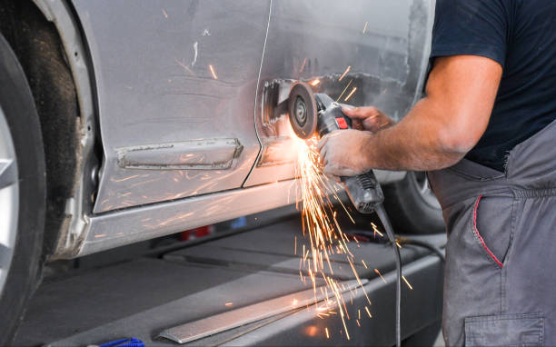 Repair service worker fix damaged car. Working with angle grinder to fix metal body Repair service worker fix damaged car. Working with angle grinder to fix metal body sheet metal stock pictures, royalty-free photos & images