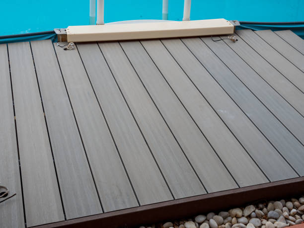 Repairing and installing new decking around a Swimming Pool. stock photo