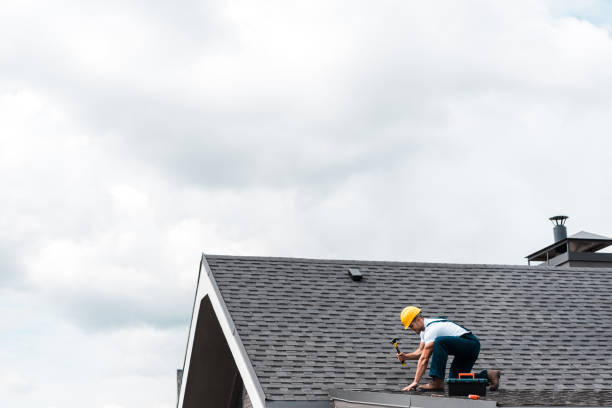 repairman in helmet holding hammer while repairing roof repairman in helmet holding hammer while repairing roof craftsperson photos stock pictures, royalty-free photos & images