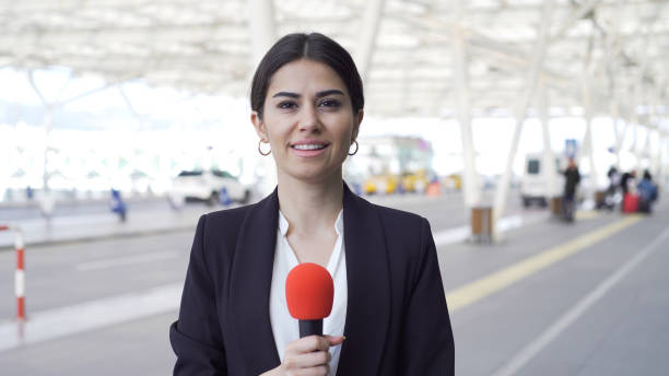 TV reporter at the airport stock photo
