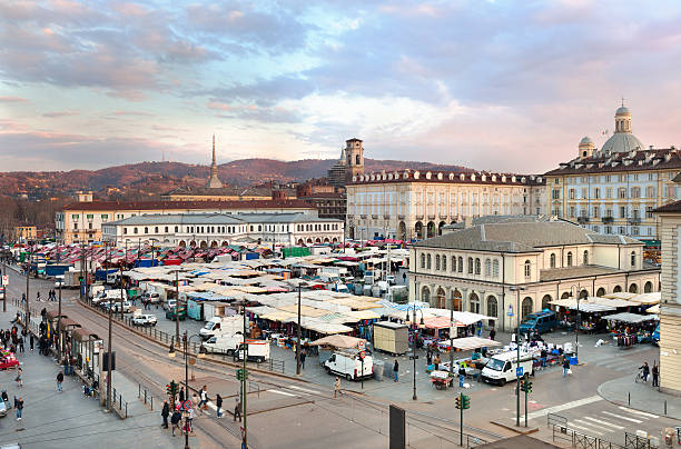 Repubblica square, Porta Palazzo 's market, Turin's hills background stock photo