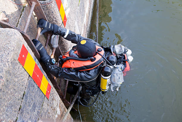 Rescue diver climbing out of the water stock photo
