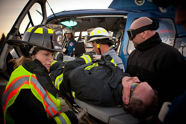 Rescue personnel loading patient into a helicopter stock photo