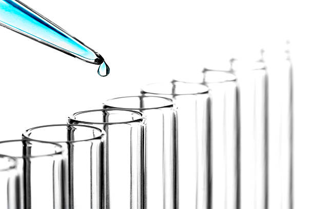 Research (High Resolution) Liquid dropping into test tube. immunology stock pictures, royalty-free photos & images