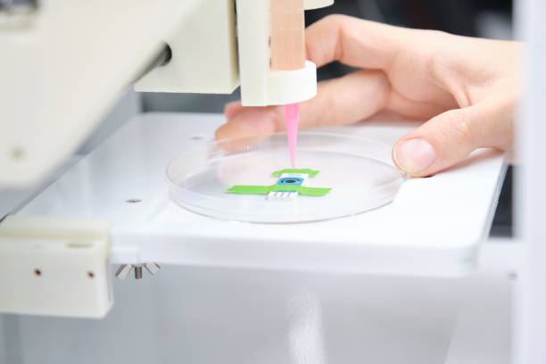 Researcher getting 3D bioprinter ready to 3D print cells onto an electrode. Biomaterials, tissue engineering concepts. stock photo