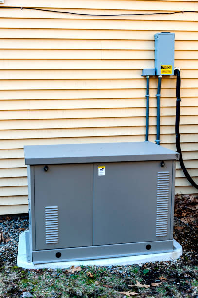 Residential Generator Residential generator on concrete pad, next to a house wall generator stock pictures, royalty-free photos & images