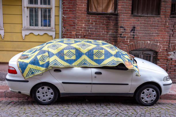 Residents prepare for the storm by covering their cars with blankets or protective materials. stock photo