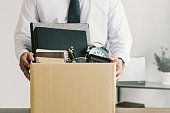 istock Resignation. businessmen holding boxes for personal belongings and resignation letters.Quitting a job,The big quit.The great Resignation. 1341022597