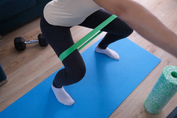 Resistance band exercises with fabric elastic equipment closeup Resistance band exercises with fabric elastic equipment. Crab walk squat exercise concept lateral surface photos stock pictures, royalty-free photos & images