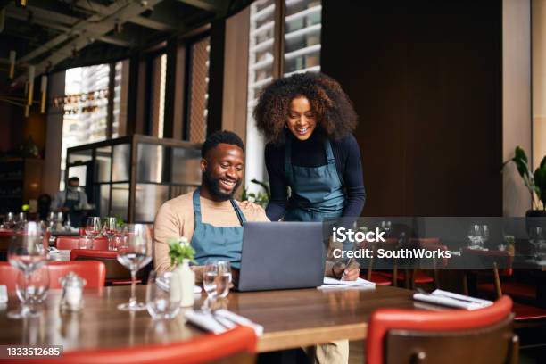 Restaurant managers working with laptop