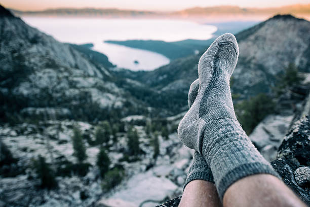 Resting in socks after a long hike in the mountains A person takes a rest after a long climb to the summit of a mountain in Lake Tahoe, California sock stock pictures, royalty-free photos & images