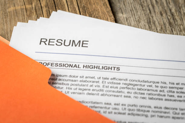 Resume Stock photograph of job resume inside orange folder. resume stock pictures, royalty-free photos & images