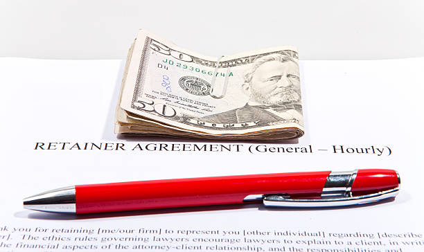 Retainer Agreement with Dollars and pen  retainer agreement stock pictures, royalty-free photos & images