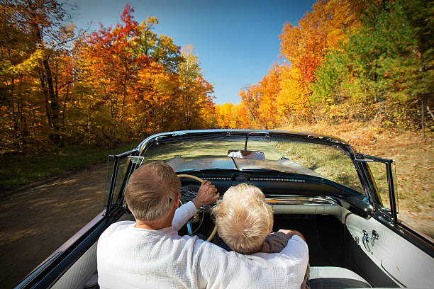 Retired couple enjoying an Autumn drive. stock photo
