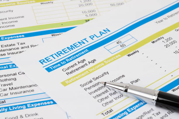 Retirement plan with pen, document is mock-up stock photo