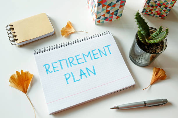 retirement plan written in notebook stock photo