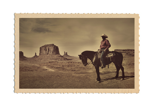 Subject: A retro postcard of a Cowboy and the landscape of the American Southwest. The image on the postcard is an original photograph produced for this stock photo, it is not a scan copy of an actual postcard image.