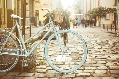 Retro blue bicycle in the European old city street, vintage toning