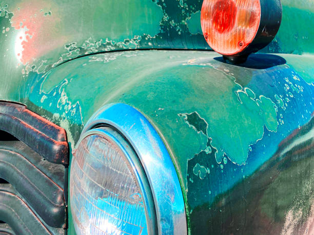 retro faded old green vintage car close up with rust in the hot desert climate stock photo