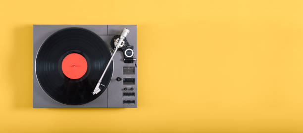 Retro record player An old record player header image on yellow background with copy space turntable stock pictures, royalty-free photos & images