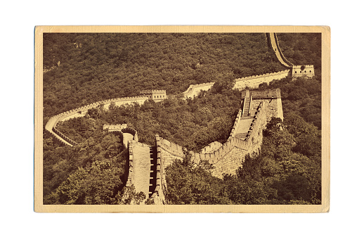 A retro style postcard photo of the scenic view of the Great Wall of China at the Mutianyu location just outside of Beijing, China. The Great Wall of China, a historic site and a very popular international tourist destination.