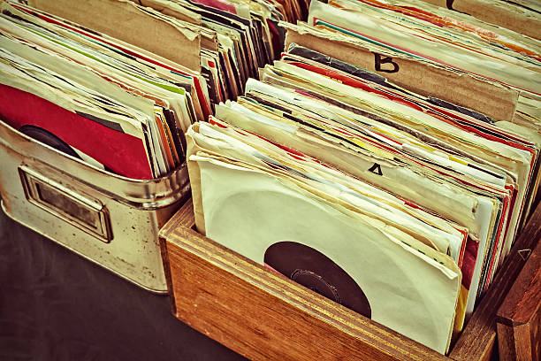 Retro styled image of lp records on a flee market Retro styled image of boxes with vinyl turntable records on a flee market deck photos stock pictures, royalty-free photos & images