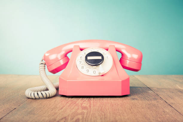 Retro telephone front mint green wall background. Old style filtered photo stock photo
