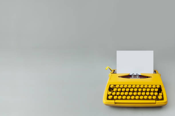 Retro typewriter background Retro typewriter on a grey paper backdrop film script stock pictures, royalty-free photos & images
