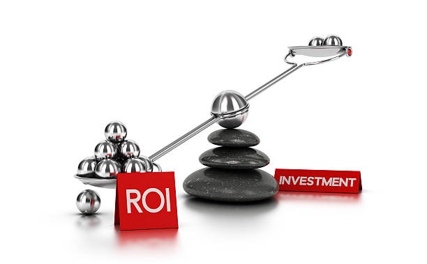 Return on Investment concept Metal spheres on a seesaw with three black pebbles over white background. Finance concept image for illustration of ROI or investment. roi stock pictures, royalty-free photos & images