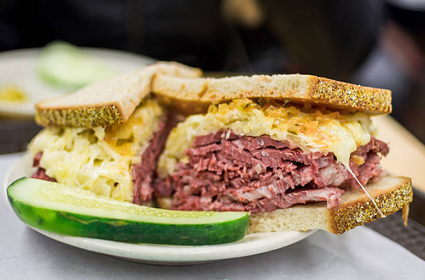 Reuben Sandwhich with Pickle Slice of American Culture Grilled Corned Beef Brisket stock pictures, royalty-free photos & images