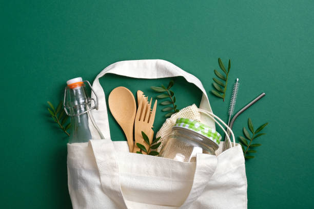 Reusable canvas shopper bag with eco friendly bamboo cutlery, metal drinking straws, glass jar and bottle. Zero waste, plastic free concept. Sustainable lifestyle Reusable canvas shopper bag with eco friendly bamboo cutlery, metal drinking straws, glass jar and bottle. Zero waste, plastic free concept. Sustainable lifestyle meal kits stock pictures, royalty-free photos & images