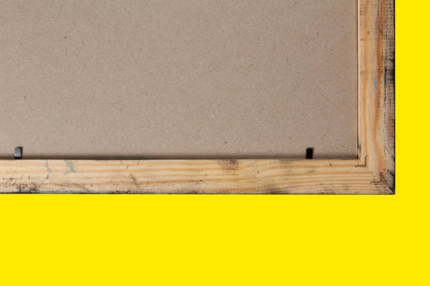 Reverse side of a wooden frame for a picture on a yellow background stock photo