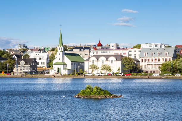 Reykjavic skyline on a sunny summer day, Iceland Reykjavik cityscape viewed from across the Tjornin lake in the heart of Iceland capital city on a sunny summer day. reykjavik stock pictures, royalty-free photos & images