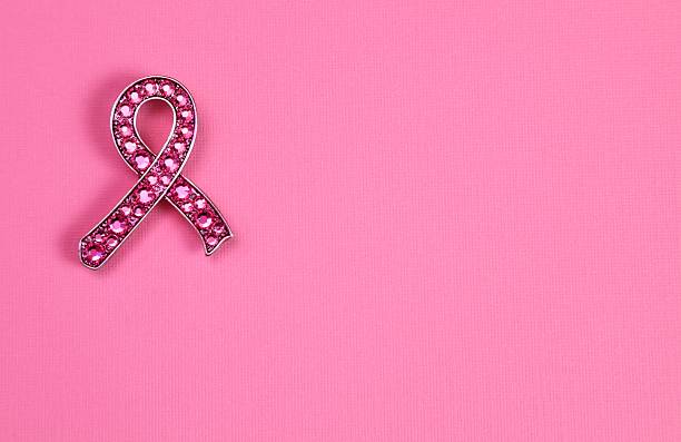 Rhinestone Breast Cancer Awareness Ribbon on pink background stock photo