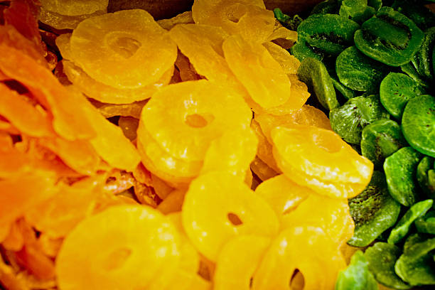 Rialto Bridge Market Market stalls at the Rialto Bridge in Venice. This is a vegetable and fruit stall with close up of dried mango, pineapple and kiwi. candied mango pineapple stock pictures, royalty-free photos & images
