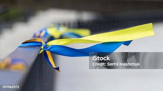 istock Ribbons in the colors of the national flag of Ukraine are tied to the handrail. 1311962973