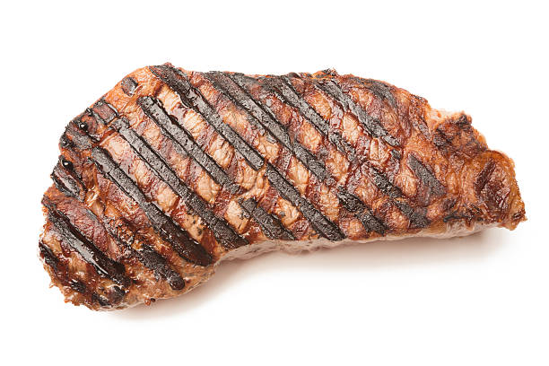 ribeye beef steak isolated on white - biefstuk stockfoto's en -beelden