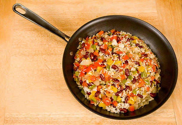 rice and beans in a skillet stock photo