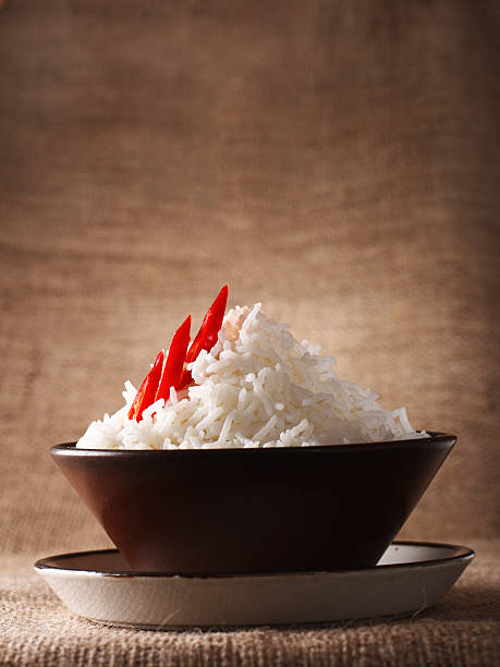 rice bowl with red hot chillies on rustic background