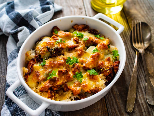 Rice casserole with barbecue chicken breast, cheese and vegetables Rice casserole with barbecue chicken breast, cheese and vegetables casserole dish stock pictures, royalty-free photos & images