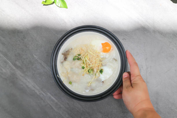 rice gruel or rice porridge or congee with pork liver, pork and egg  soft-boiled egg stock pictures, royalty-free photos & images