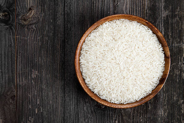 Rice in a wooden bowl stock photo