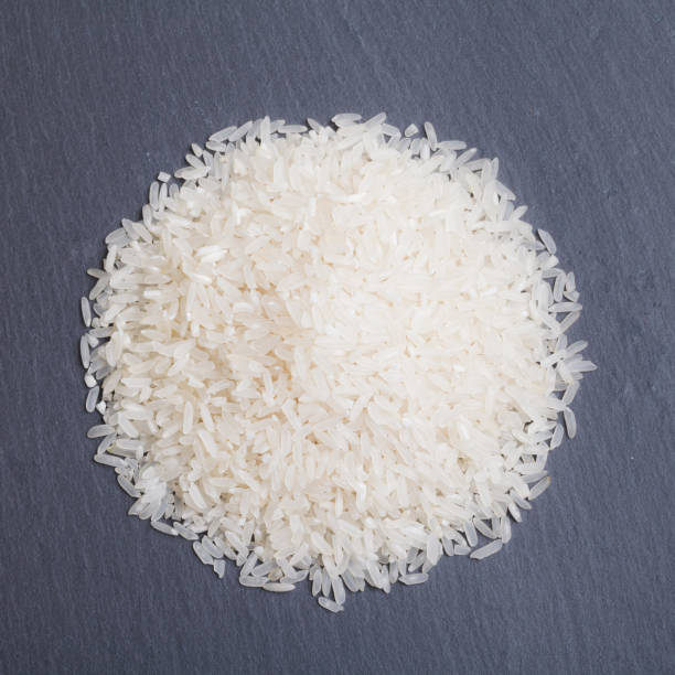 Rice isolated on black stone table stock photo