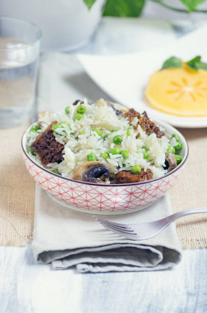 Rice with peas, mushrooms and seitan stock photo