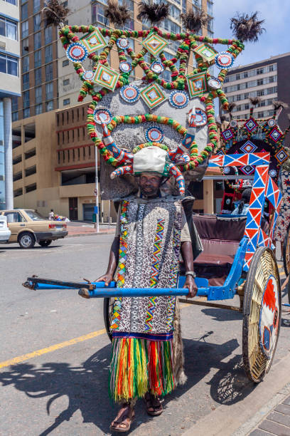 A rickshaw zulu warrior seen here with his chariot A rickshaw zulu warrior seen here with his chariot, offering rides to tourists around Durban's beachfront road. durban stock pictures, royalty-free photos & images