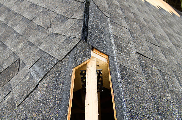 Ridge Vent "View of a partially shingled house roof, showing the cut-out for a ridge vent at the peak of the roof.Similar Images:" mountain ridge stock pictures, royalty-free photos & images