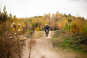 Extreme sports athlete riding his enduro motorbike on a mountain dirt road in Serbia