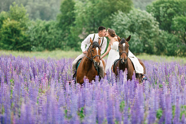 Riding the newlyweds on the field stock photo